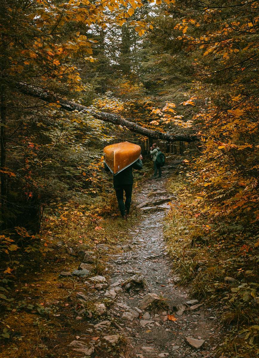 boundary waters canoe area wilderness person carrying brown canoe ely
